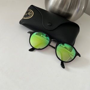 Black frames with green mirrored lenses